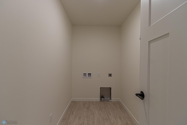 clothes washing area featuring electric dryer hookup, washer hookup, and light wood-type flooring