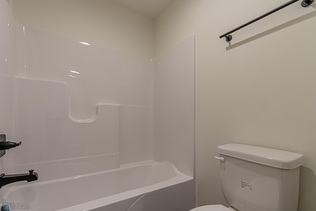 bathroom with tub / shower combination and toilet