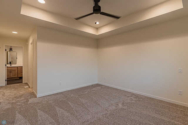 carpeted empty room with baseboards, recessed lighting, a raised ceiling, and ceiling fan