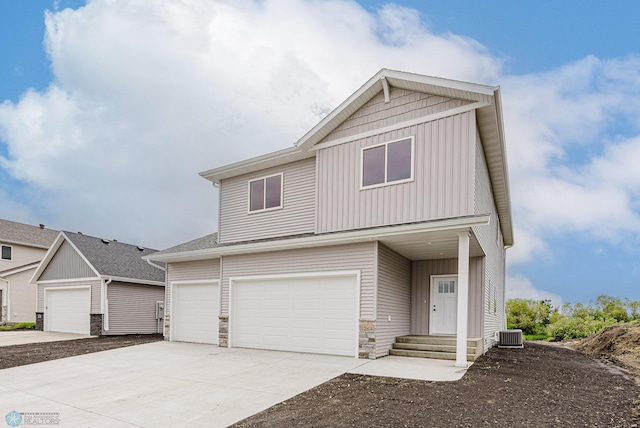 1264 Marlys Dr W, West Fargo, ND 58078 - view of front of property with stone siding, board and batten siding, an attached garage, and concrete driveway