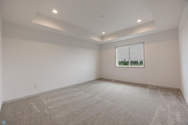 1264 Marlys Dr W, West Fargo, ND 58078 - empty room with a raised ceiling, recessed lighting, and light carpet