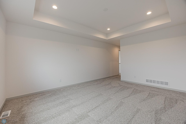 1264 Marlys Dr W, West Fargo, ND 58078 - empty room with a raised ceiling, light colored carpet, and recessed lighting