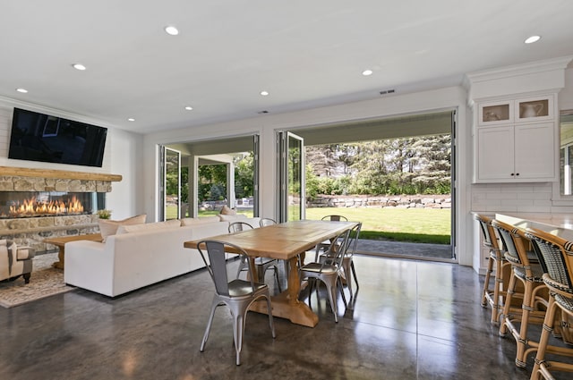 dining space with a stone fireplace