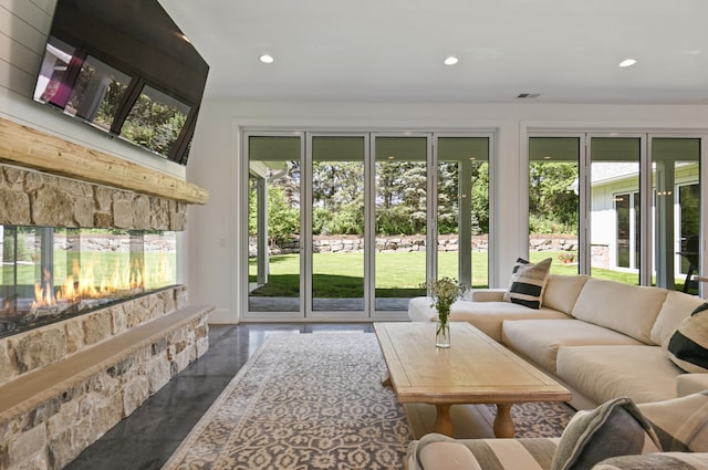 sunroom featuring a fireplace