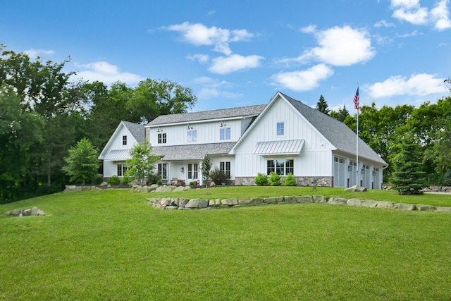 back of property with a garage and a lawn