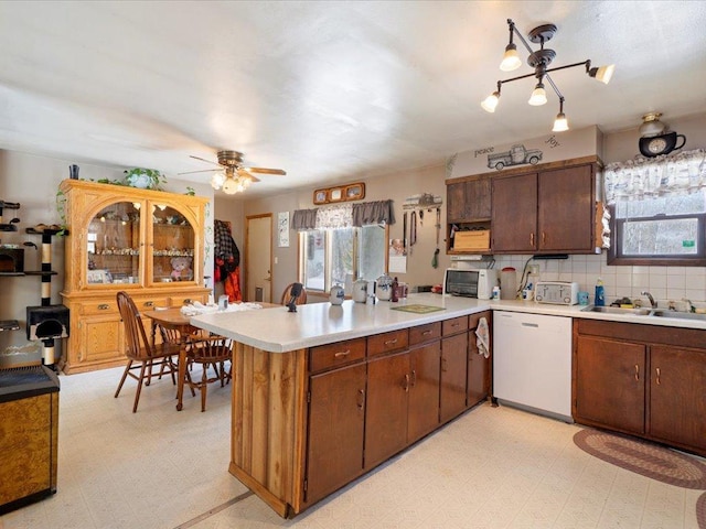 31552 County 23, Akeley, MN 56433 - kitchen with a peninsula, light floors, white dishwasher, and light countertops