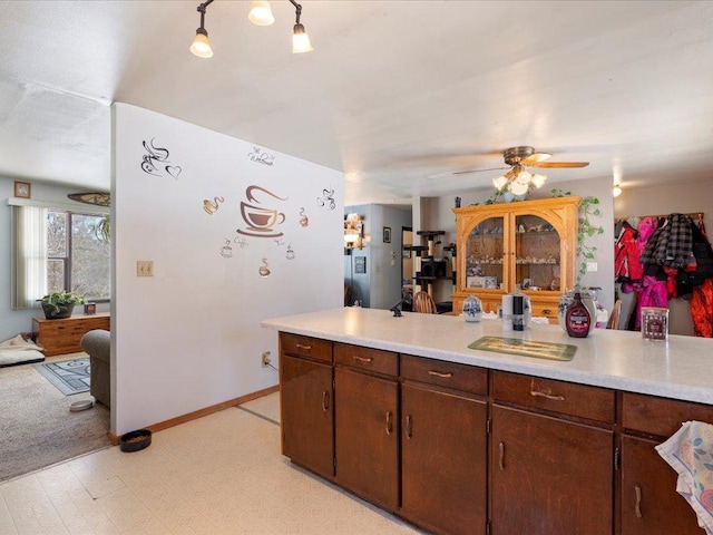 31552 County 23, Akeley, MN 56433 - kitchen featuring dark brown cabinetry, a ceiling fan, baseboards, light countertops, and light floors