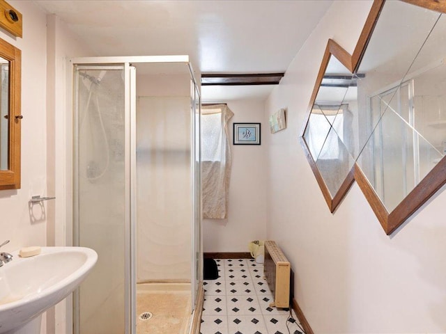 31552 County 23, Akeley, MN 56433 - bathroom featuring a stall shower, radiator heating unit, baseboards, and a sink
