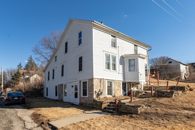 exterior space featuring stone siding