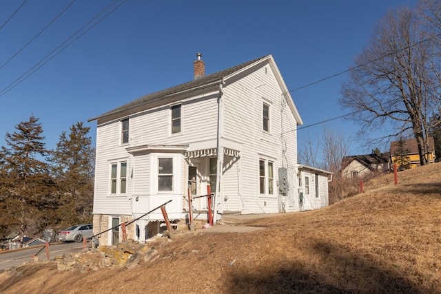 view of front facade with a chimney