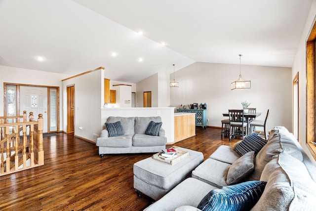 living room featuring dark hardwood / wood-style flooring and vaulted ceiling