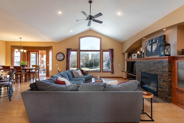 living room with plenty of natural light, a fireplace, and light wood-type flooring