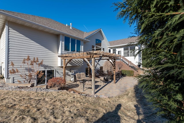 back of property with stairs, a patio area, and a pergola