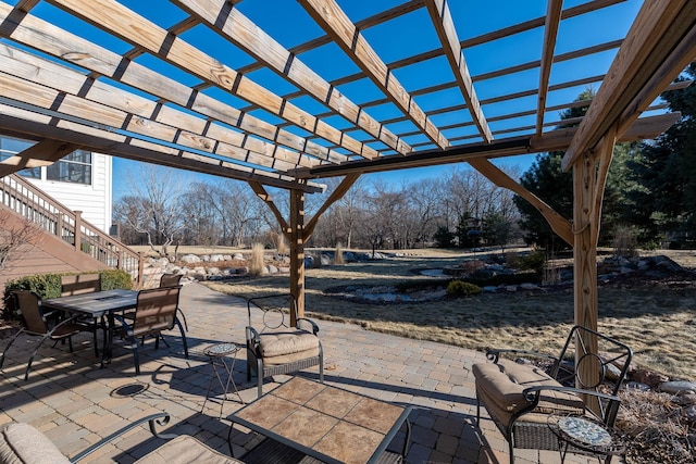 view of patio with outdoor dining space and a pergola