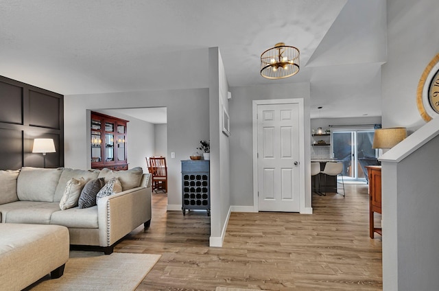 living room featuring a chandelier and light hardwood / wood-style floors