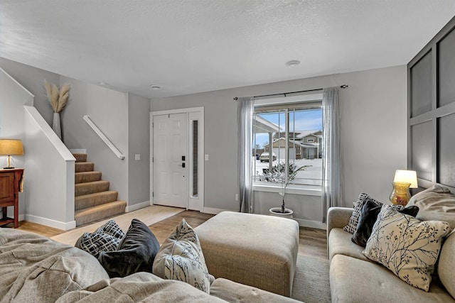 living room featuring a textured ceiling and light wood-type flooring