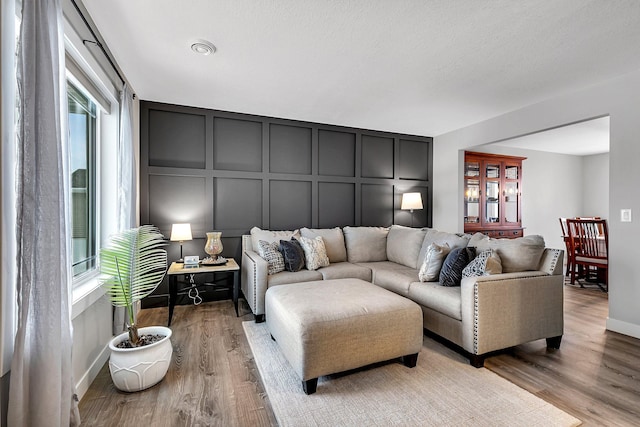 living room featuring plenty of natural light and light hardwood / wood-style flooring