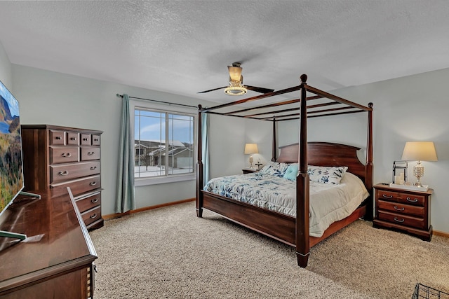 carpeted bedroom with ceiling fan and a textured ceiling