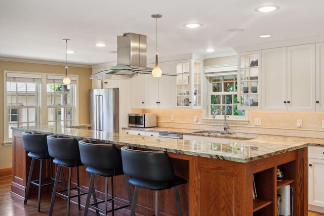 kitchen with stainless steel appliances, sink, hanging light fixtures, and white cabinets