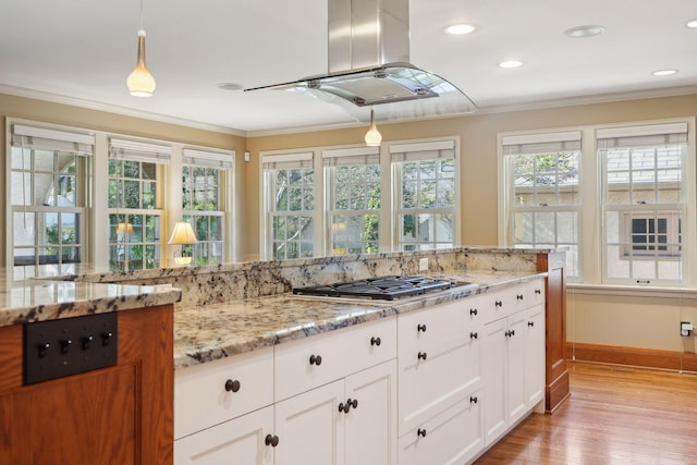 kitchen featuring hanging light fixtures, crown molding, and stainless steel gas cooktop