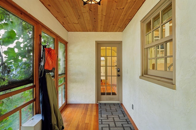 doorway to outside featuring wood ceiling and wood-type flooring