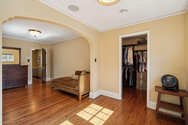 interior space featuring ornamental molding and dark hardwood / wood-style flooring