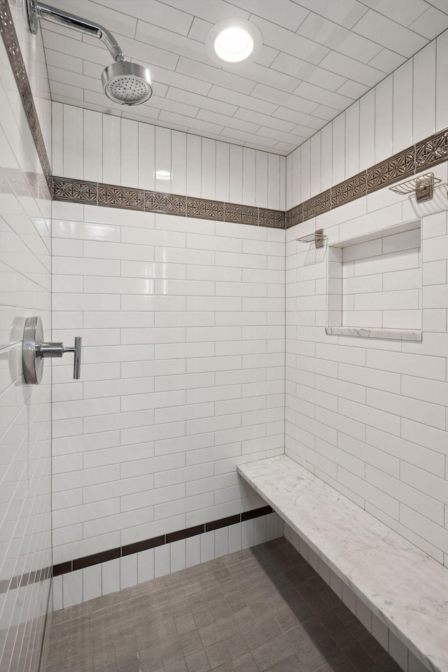 bathroom with a tile shower