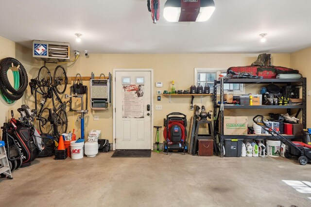 garage featuring a garage door opener and a workshop area