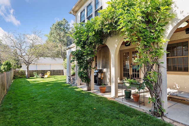 view of yard featuring a patio area and french doors