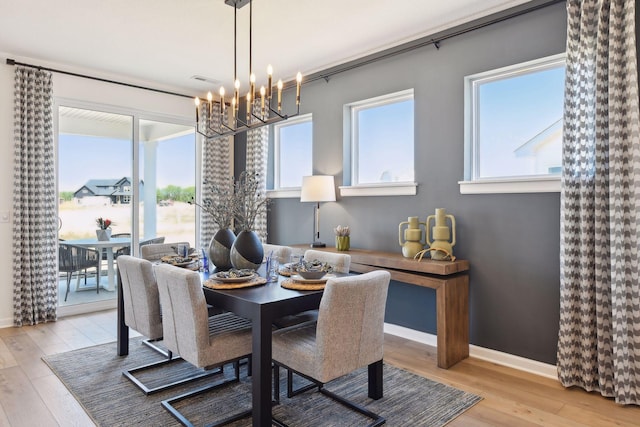 dining room featuring a notable chandelier and light wood-type flooring