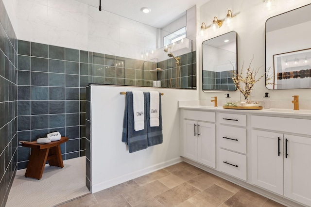 bathroom featuring vanity, tiled shower, and tile walls