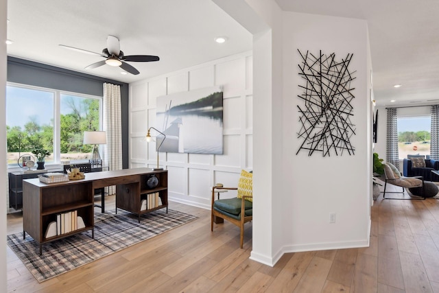 office area with light hardwood / wood-style flooring and ceiling fan