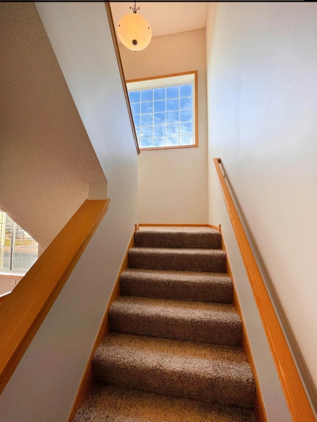 staircase featuring baseboards