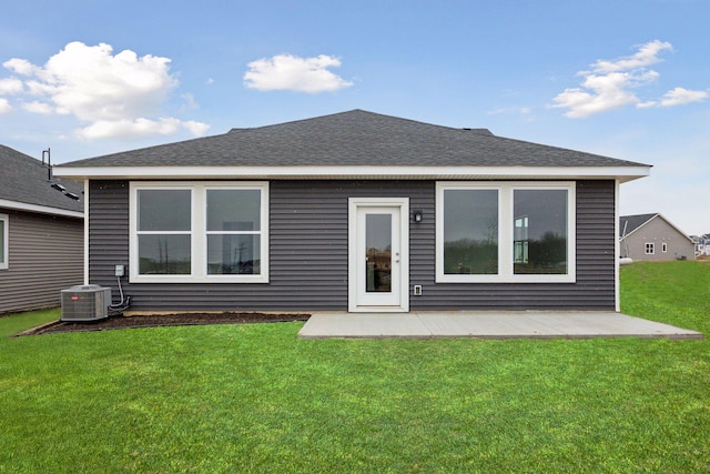 back of property with a lawn, a patio, and central air condition unit