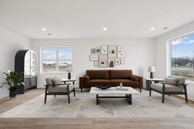 living room featuring recessed lighting, visible vents, baseboards, and light wood-style floors