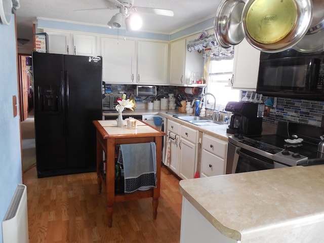 kitchen with tasteful backsplash, ceiling fan, a sink, and black appliances