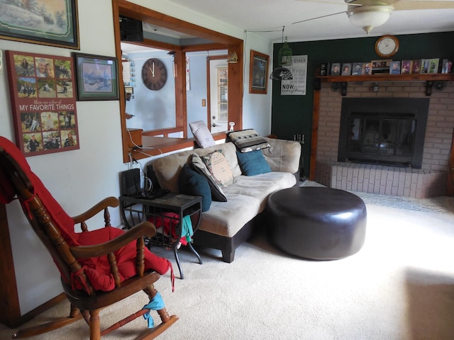 living area featuring carpet, ceiling fan, and a fireplace