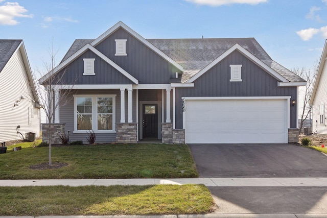 craftsman house featuring a garage, cooling unit, covered porch, and a front lawn