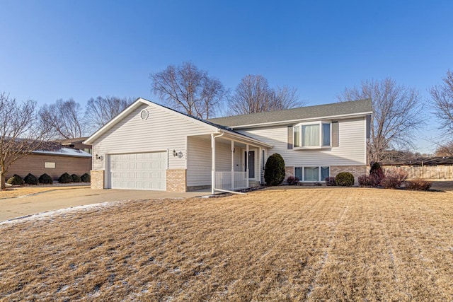 tri-level home with a garage and a front lawn