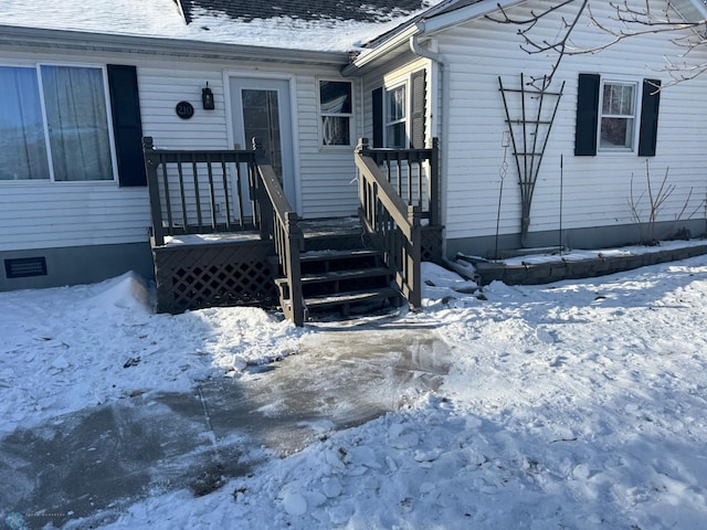 view of snow covered property entrance