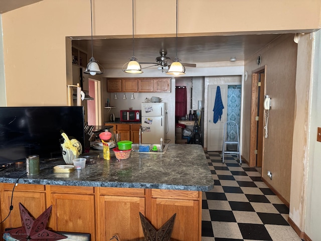 kitchen with white refrigerator, pendant lighting, and ceiling fan