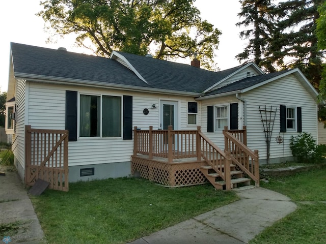 rear view of property featuring a lawn