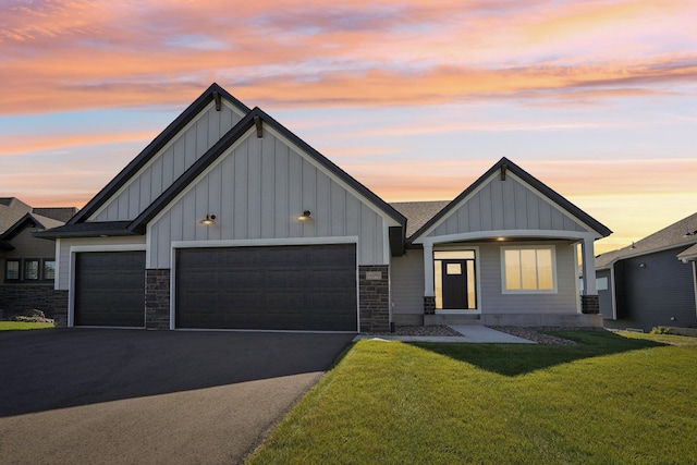 view of front of house with a garage and a lawn