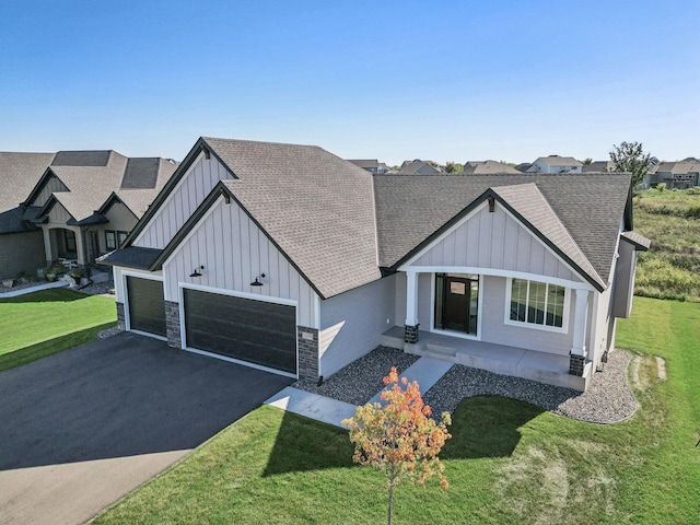 view of front of property with a garage and a front lawn