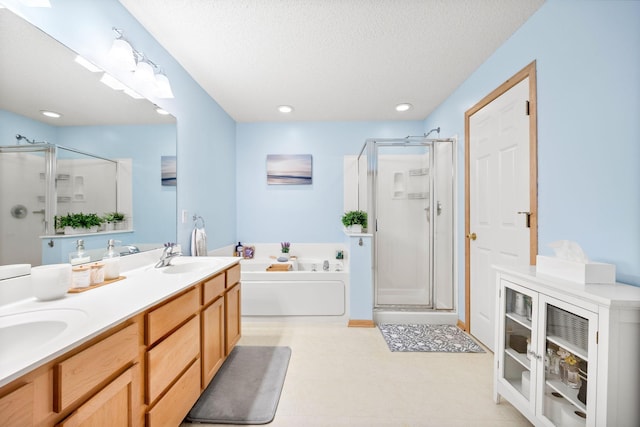 13905 52nd Ave N Unit 701, Plymouth, MN 55446 - bathroom with a stall shower, a bath, double vanity, a textured ceiling, and recessed lighting
