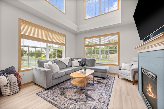 13905 52nd Ave N Unit 701, Plymouth, MN 55446 - living room with a glass covered fireplace, healthy amount of natural light, light wood finished floors, and a high ceiling