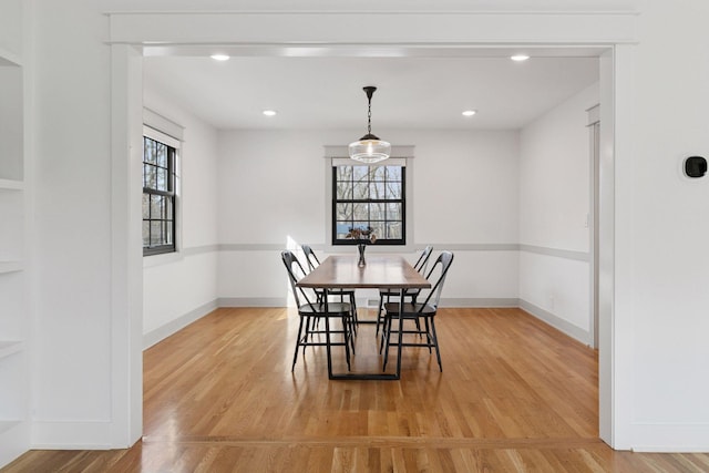 dining room with light wood-type flooring, a healthy amount of sunlight, baseboards, and recessed lighting