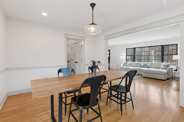 dining room featuring baseboards, recessed lighting, and light wood-style floors