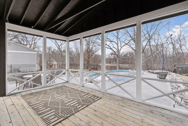 unfurnished sunroom with lofted ceiling