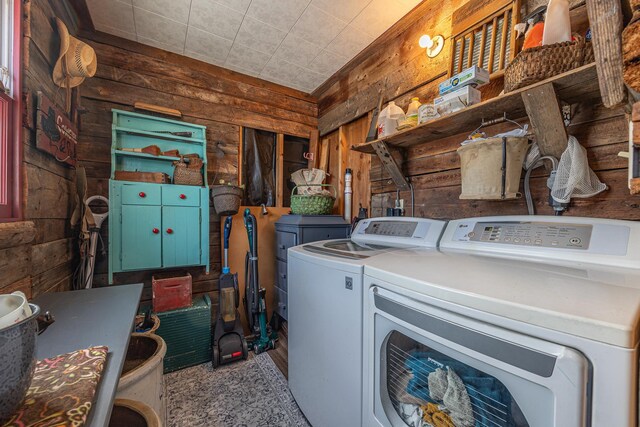 laundry room featuring independent washer and dryer, laundry area, and wood walls